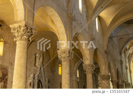 Church interior with ancient arches and stone columns in Massa Marittima 135101587