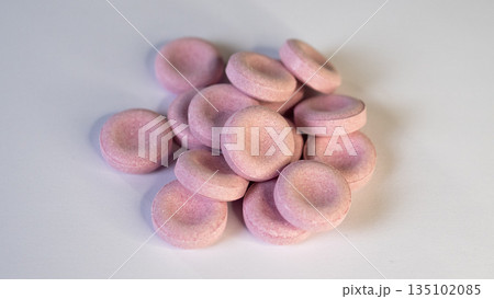 Pink Candy Discs Piled On White Surface, Bright Minimalist Studio Flatlay With Soft Shadows And Smooth Matte Texture, Ideal For Product Listing And Modern Confectionery Branding 135102085