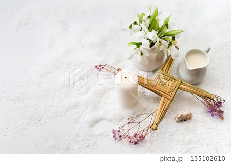 Brigid's cross, snowdrops, candle celebrating imbolc festival 135102610