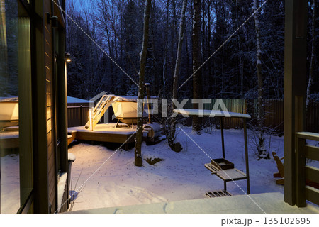 Evening scene with frosted glass doors and winter landscape Evening scene with frosted glass doors and winter landscape 135102695