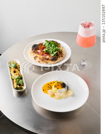 Fashionable midmorning assembly with modern table arrangements Fashionable midmorning assembly with modern table arrangements 135102697