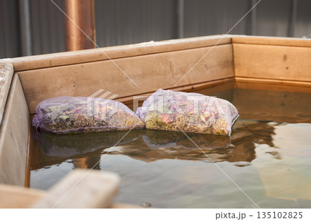 Experience Calming Herbal Bathing Ceremony With Aromatic Sachets Steeped In Wooden Tubs Of Water Experience Calming Herbal Bathing Ceremony With Aromatic Sachets Steeped In Wooden Tubs Of Water 135102825
