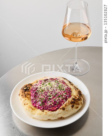 closeup beetroot pizza with rose wine glass, editorial studio closeup beetroot pizza with rose wine glass, editorial studio 135102827
