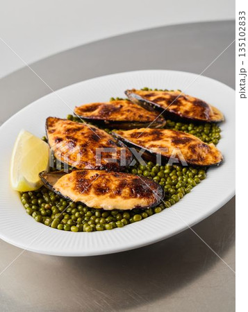 close vertical shot of baked mussels on peas, editorial close vertical shot of baked mussels on peas, editorial 135102833