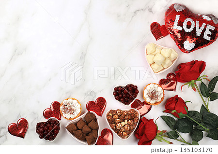 Food for Valentine's Day or Women's Day, Gourmet heart shaped chocolate candies, sugar cranberry, meringue and rose flowers, greeting card, advertising banner or store invitation. 135103170