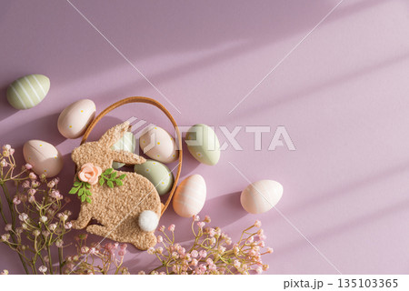Pastel Easter Bunny Basket with Eggs and Flowers on Lavender Background Pastel Easter Bunny Basket with Eggs and Flowers on Lavender Background 135103365