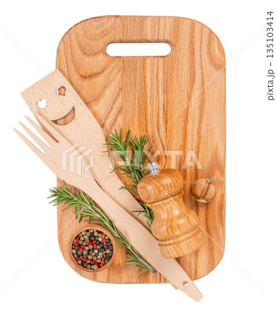 Wooden kitchen cutting board with utensils, spices and rosemary isolated on white background, top view Wooden kitchen cutting board with utensils, spices and rosemary isolated on white background, top view 135103414