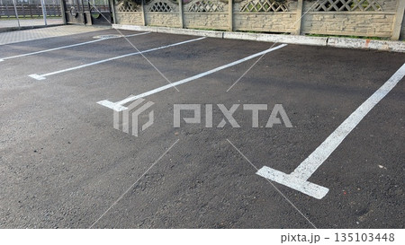 Concrete Parking Area, An Empty Roadway Surface With Aligned Parking Zones And Subdued Morning Light Concrete Parking Area, An Empty Roadway Surface With Aligned Parking Zones And Subdued Morning Light 135103448