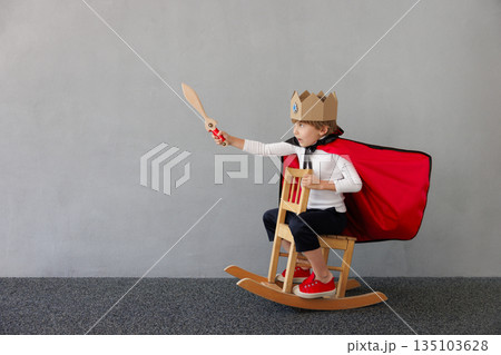 Funny child pretend to be knight. Happy kid having fun at home 135103628
