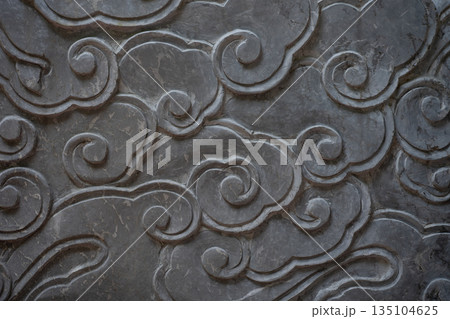 Stone carving depicting stylized clouds forming a decorative pattern Stone carving depicting stylized clouds forming a decorative pattern 135104625