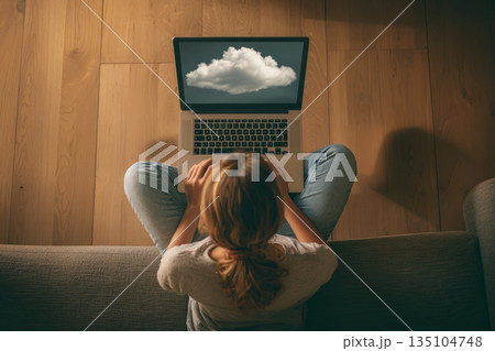 IT specialist accesses cloud files from laptop in modern office setting while working on data analysis and using SaaS dashboard features 135104748