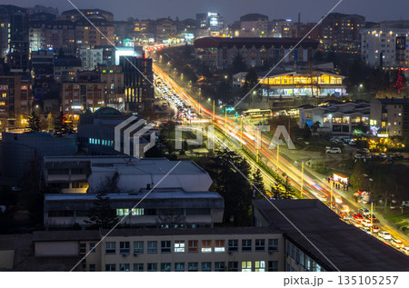 Modern cityscape of Pristina in Kosovo at night with illuminated skyline, residential districts, office towers and long exposure highlighted traffic trails 135105257