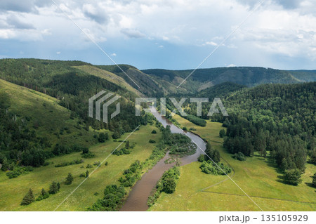 River flowing through forested valley under cloudy sky River flowing through forested valley under cloudy sky 135105929