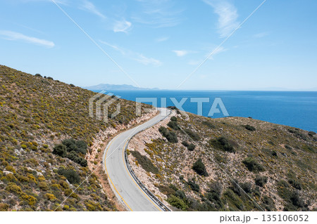 Winding coastal road traversing a picturesque hillside in Crete, Greece 135106052