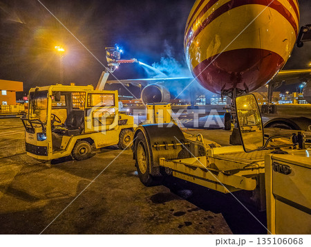 Aircraft De-icing at Night on an Airport Tarmac Aircraft De-icing at Night on an Airport Tarmac 135106068