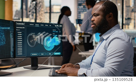 Researcher upgrades turbine component with AI to maximize sustainability. RD office expert uses artificial intelligence software to refine blade aerodynamics, boosting clean energy output, camera B 135109528