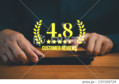 Customer hands using a smartphone with glowing 4.8 star rating and customer reviews. Concept of online feedback, business reputation, satisfaction score, quality service evaluation, and brand trust. 135109729
