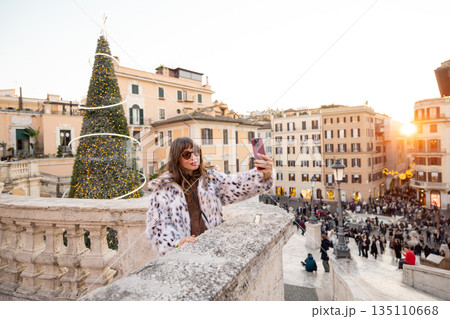 Woman taking a festive selfie near the Spanish Steps in Rome 135110668