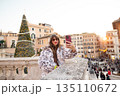 Woman taking a festive selfie near the Spanish Steps in Rome 135110672