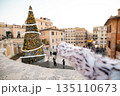 Woman pointing at festive Christmas tree near the Spanish Steps in Rome 135110673