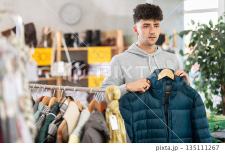 Regular customer guy chooses color and style of down jacket Regular customer guy chooses color and style of down jacket 135111267