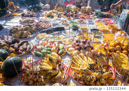 Various kind of food on table offering to the god or angel in mixed culture of Buddhist and Hindu religion in Thailand. Offerings, which can be flowers, food, or other gifts, are part of puja (worship Various kind of food on table offering to the god or angel in mixed culture of Buddhist and Hindu religion in Thailand. Offerings, which can be flowers, food, or other gifts, are part of puja (worship 135112344