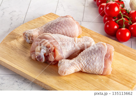 Fresh raw chicken drumsticks over board Fresh raw chicken drumsticks over board 135113662