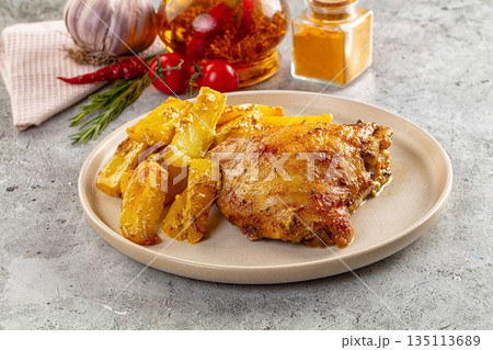 Baked chicken thighs with potatoes 135113689