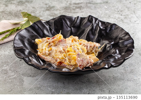 Italian pasta fettuccine with prosciutto 135113690