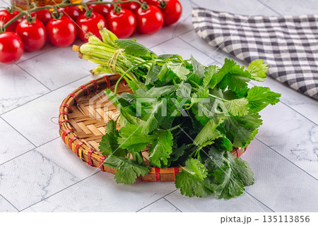 Heap of green fresh coriander stems 135113856