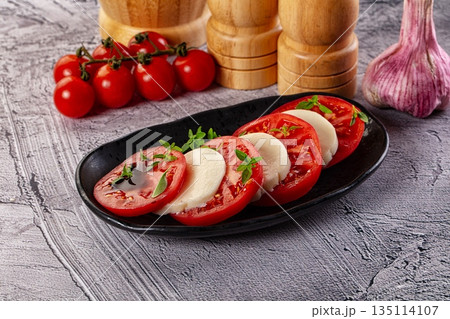 Italian caprese salad with mozzarella, tomato and basil Italian caprese salad with mozzarella, tomato and basil 135114107