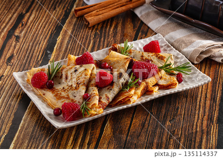 Sweet homemade pancakes with raspberry 135114337