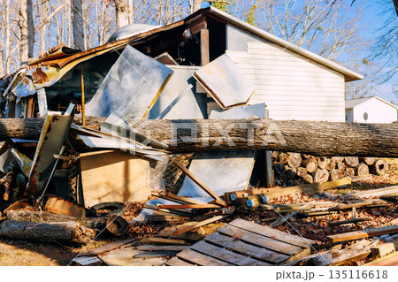 Tree has fallen on house, damaging structure spreading debris across yard 135116618