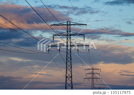Landscape with rainbow behind electricity pylon 135117975