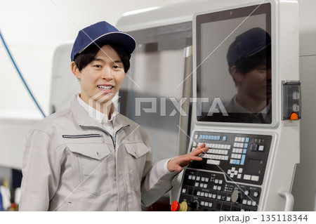 工場の操作盤の前で働く男性作業員 135118344