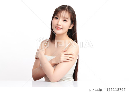 A beautiful young Asian woman with clean, fresh skin against a white background. Skincare, facial treatment, cosmetology, beauty, and spa. An elegant portrait of an Asian woman. A beautiful young Asian woman with clean, fresh skin against a white background. Skincare, facial treatment, cosmetology, beauty, and spa. An elegant portrait of an Asian woman. 135118765
