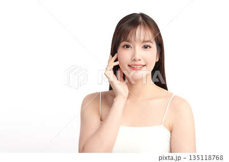 A beautiful young Asian woman with clean, fresh skin against a white background. Skincare, facial treatment, cosmetology, beauty, and spa. An elegant portrait of an Asian woman. A beautiful young Asian woman with clean, fresh skin against a white background. Skincare, facial treatment, cosmetology, beauty, and spa. An elegant portrait of an Asian woman. 135118768