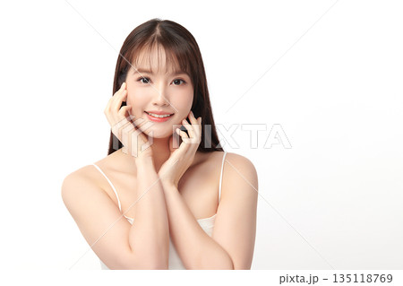 A beautiful young Asian woman with clean, fresh skin against a white background. Skincare, facial treatment, cosmetology, beauty, and spa. An elegant portrait of an Asian woman. A beautiful young Asian woman with clean, fresh skin against a white background. Skincare, facial treatment, cosmetology, beauty, and spa. An elegant portrait of an Asian woman. 135118769