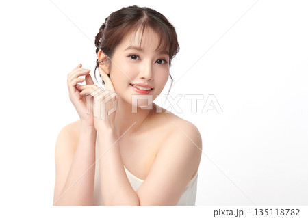 A beautiful young Asian woman with clean, fresh skin against a white background. Skincare, facial treatment, cosmetology, beauty, and spa. An elegant portrait of an Asian woman. A beautiful young Asian woman with clean, fresh skin against a white background. Skincare, facial treatment, cosmetology, beauty, and spa. An elegant portrait of an Asian woman. 135118782