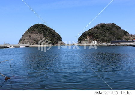 快晴の早春の青空をバックに日本海に浮かぶ居組漁港の二つの小島 快晴の早春の青空をバックに日本海に浮かぶ居組漁港の二つの小島 135119166