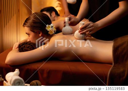 Hot herbal ball spa massage body treatment with couple customer. Quiescent Hot herbal ball spa massage body treatment with couple customer. Quiescent 135119583