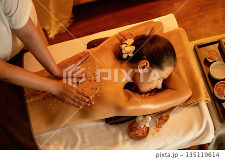 Woman customer having exfoliation treatment in luxury spa. Quiescent 135119614