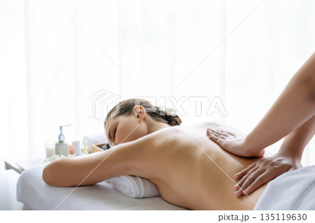 Caucasian woman customer enjoying relaxing anti-stress massage. Quiescent Caucasian woman customer enjoying relaxing anti-stress massage. Quiescent 135119630
