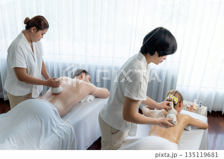 Hot herbal ball spa massage body treatment at day spa . Quiescent 135119681