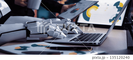 Futuristic Workplace Setting Featuring Robotic Arm Mockup, Laptop, Business Reports, and Coffee Mug in Collaborative Environment. Noogenesis 135120240