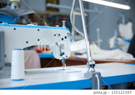 Precise industrial sewing, high-precision industrial stitching on blue surface 135122397