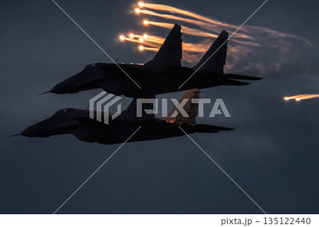 Aircraft fighter jets against the background of dark blue sky Aircraft fighter jets against the background of dark blue sky 135122440