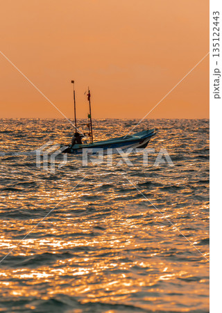 Zanzibar, Tanzania, 09 December 2021: African fishermen on a motor boat fish in the Ocean on sunset 135122443