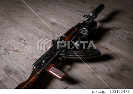 Modern kalashnikov assault rifle with underbarrel grenade launcher on wooden background 135122478