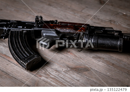 Automatic weapons kalashnikov assault rifle on wooden background. close up view 135122479